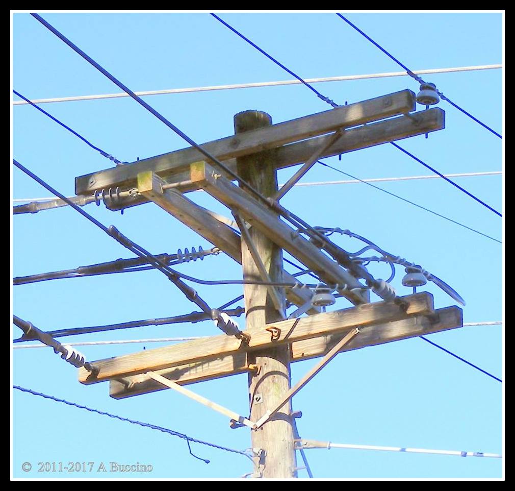 Crowded sky - telephone wires slice horizon by anthony buccino