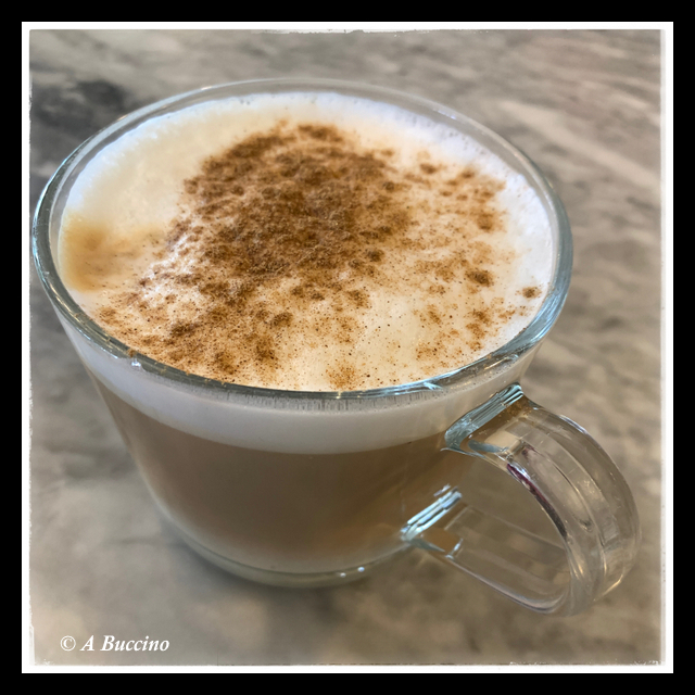 Cinnamon topped cappuccino, glass mug