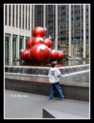 Street photography, big balls and small boy on a NY street at Christmas time